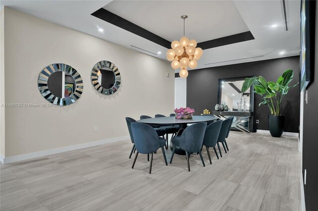4701 N Meridian Ave Unit 510, Miami Beach, FL 33140 - dining space with a chandelier, recessed lighting, baseboards, and a tray ceiling