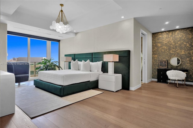 bedroom featuring light hardwood / wood-style floors and a chandelier