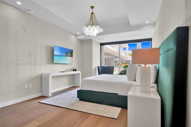 bedroom featuring a chandelier and hardwood / wood-style floors