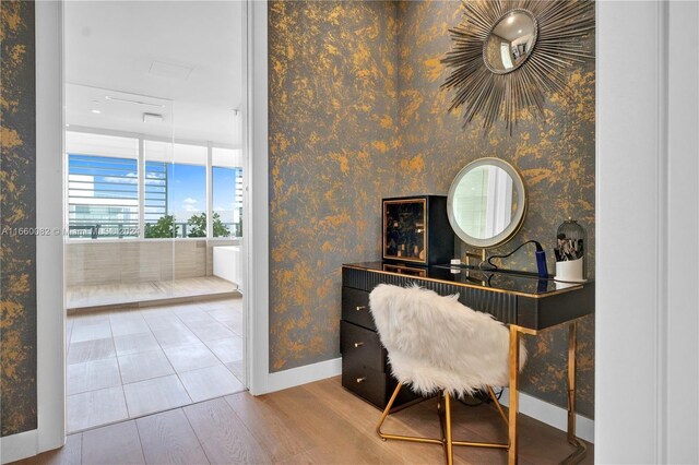4701 N Meridian Ave Unit 510, Miami Beach, FL 33140 - office area featuring baseboards, wood finished floors, wallpapered walls, and floor to ceiling windows