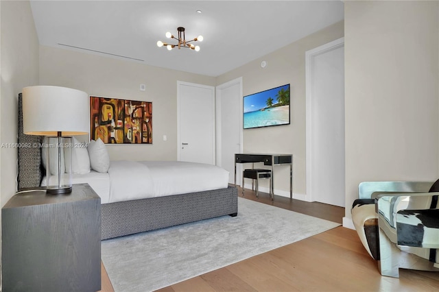 bedroom featuring a chandelier and hardwood / wood-style floors