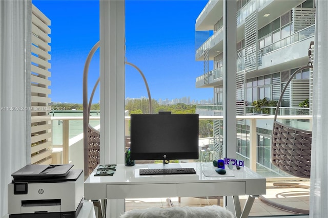 home office featuring plenty of natural light and tile patterned flooring