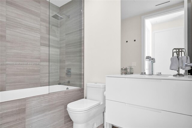 4701 N Meridian Ave Unit 510, Miami Beach, FL 33140 - full bathroom with vanity, tiled shower / bath, and toilet