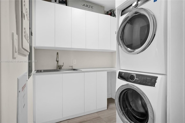 4701 N Meridian Ave Unit 510, Miami Beach, FL 33140 - laundry room with estacked washer and dryer, cabinet space, and light wood finished floors