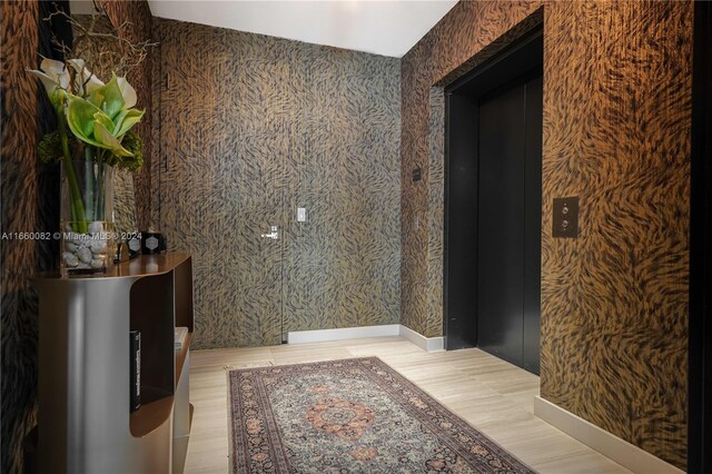 bathroom with hardwood / wood-style flooring and elevator