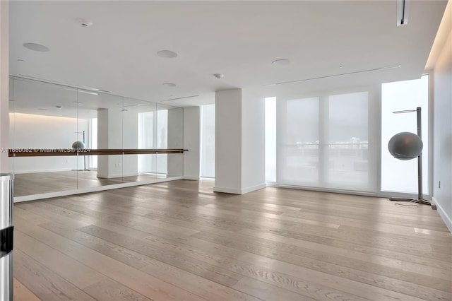 4701 N Meridian Ave Unit 510, Miami Beach, FL 33140 - spare room with light wood-style flooring, plenty of natural light, and baseboards