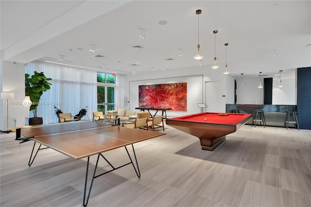 playroom with light hardwood / wood-style floors and billiards