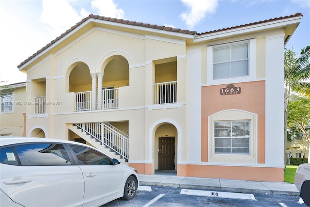 mediterranean / spanish-style house with a balcony