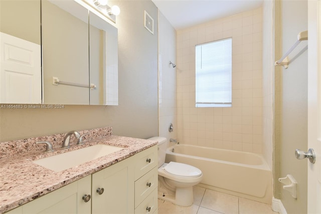 full bathroom featuring vanity, toilet, tiled shower / bath combo, and tile patterned floors