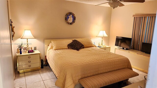 bedroom with ceiling fan and light tile patterned floors