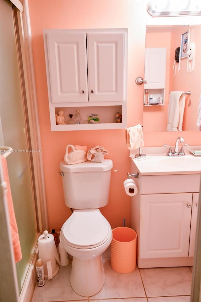 bathroom with tile patterned floors, vanity, and toilet