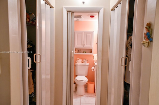 bathroom with toilet and tile patterned floors