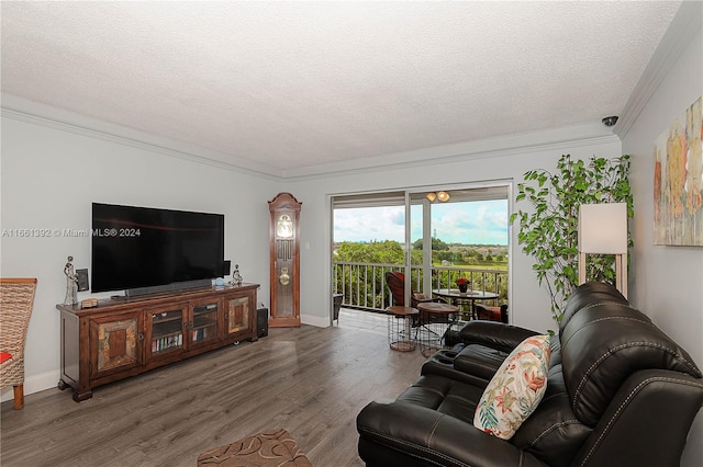 living room featuring wood-type flooring, a textured ceiling, and crown molding