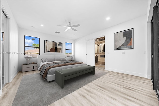 bedroom with light hardwood / wood-style floors, ceiling fan, and ensuite bathroom