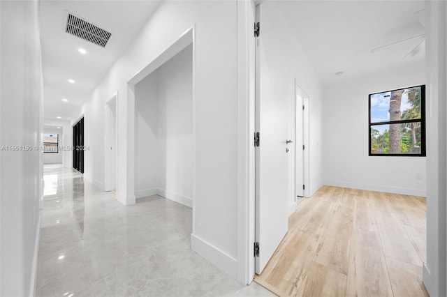 corridor with light hardwood / wood-style flooring