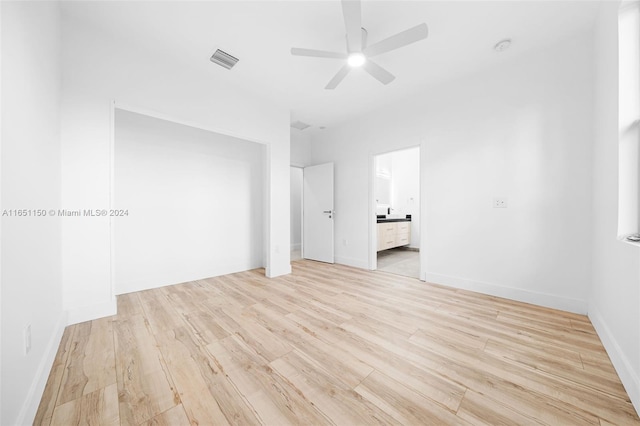 spare room with ceiling fan and light wood-type flooring