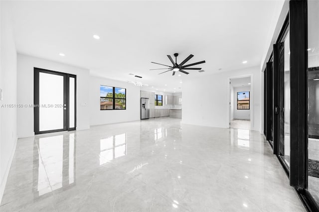 unfurnished living room with ceiling fan