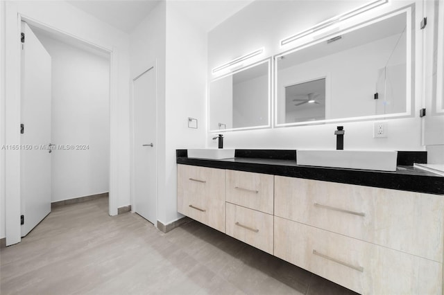 bathroom with ceiling fan, vanity, and wood-type flooring