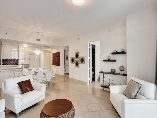 living room featuring light tile patterned flooring and sink