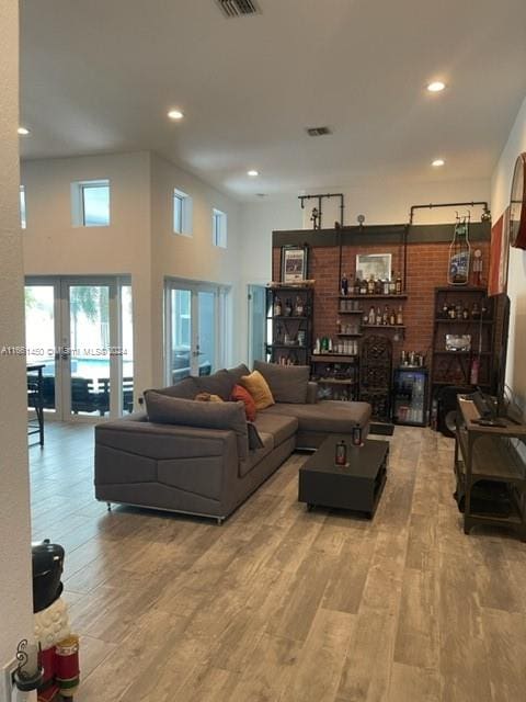 living room featuring a towering ceiling and hardwood / wood-style flooring