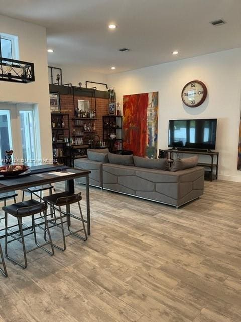 living room with light wood-type flooring and a wealth of natural light