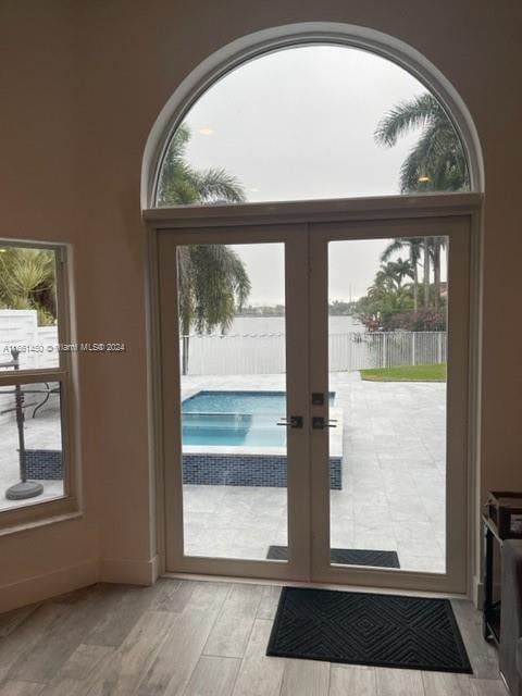 doorway to outside with light hardwood / wood-style floors and french doors