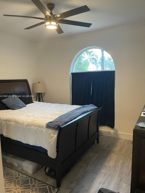 bedroom with ceiling fan and hardwood / wood-style flooring