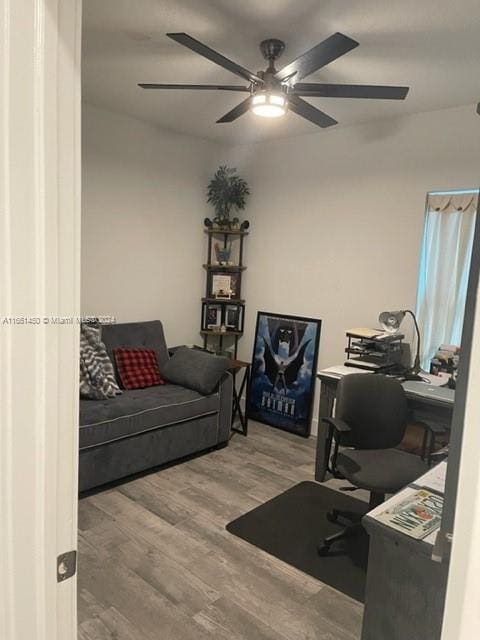 home office featuring wood-type flooring and ceiling fan