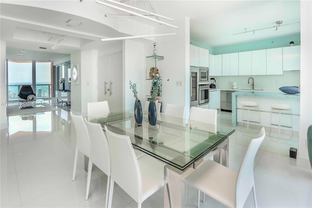 dining room with sink and light tile patterned floors