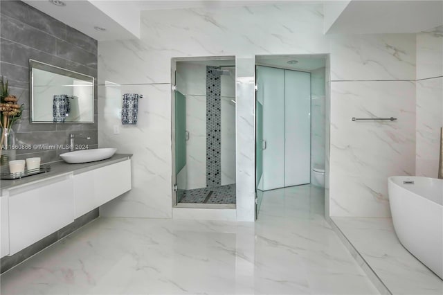 full bathroom featuring shower with separate bathtub, toilet, tile walls, and vanity