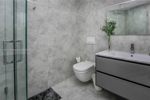 bathroom featuring tile walls, an enclosed shower, vanity, and toilet