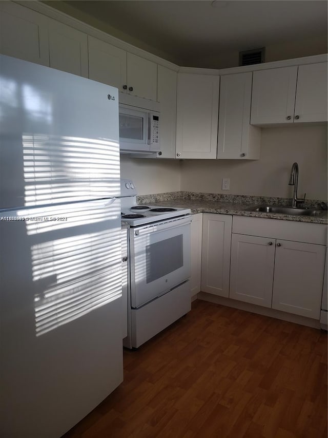 200 SW 132nd Way Unit 104L, Pembroke Pines, FL 33027 - kitchen featuring white appliances, dark wood-type flooring, white cabinets, and light stone counters