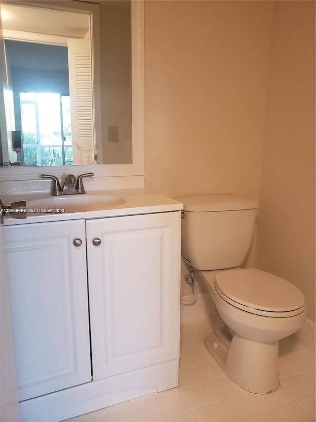 bathroom featuring tile patterned flooring, vanity, and toilet