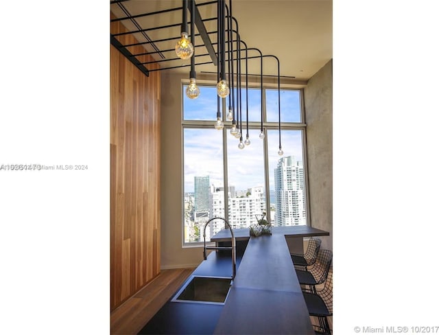 interior space with wood-type flooring, a notable chandelier, and sink