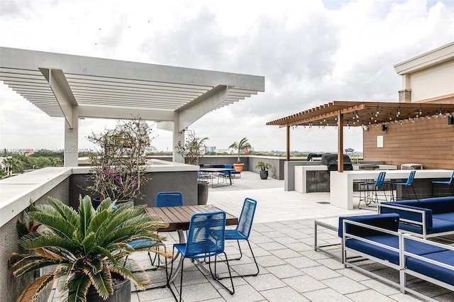 view of patio / terrace with a pergola, a bar, and exterior kitchen