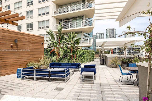 view of patio featuring outdoor lounge area and a balcony