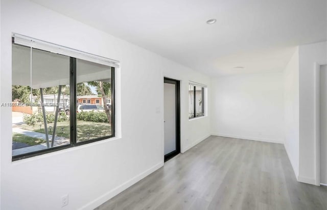 empty room with light hardwood / wood-style flooring