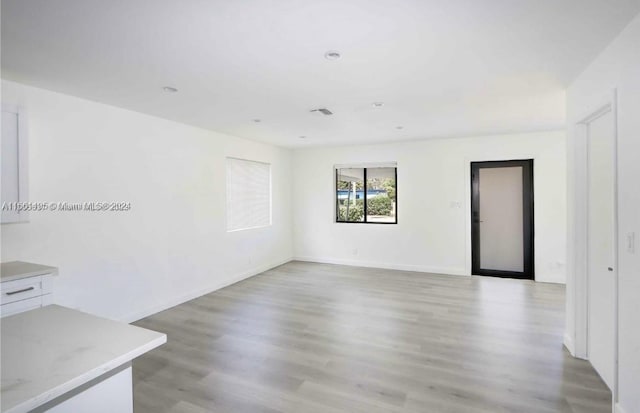 spare room with light hardwood / wood-style flooring