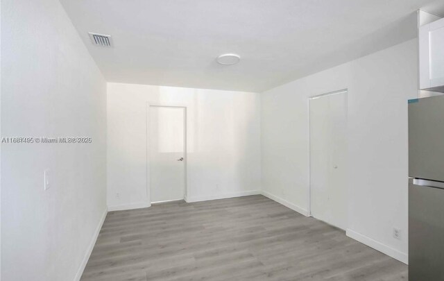 spare room featuring light wood-type flooring