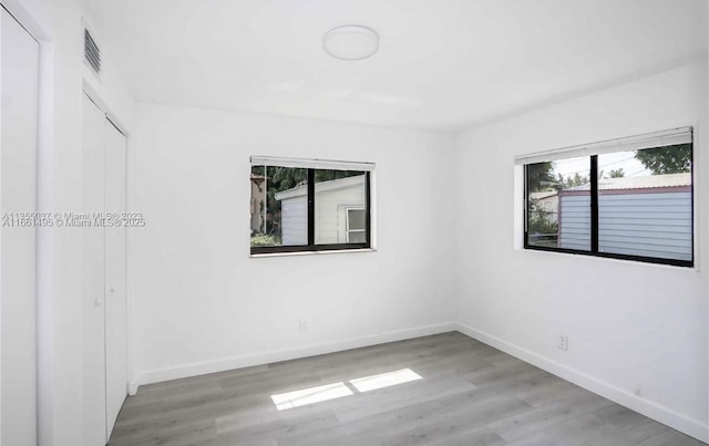 spare room with hardwood / wood-style flooring