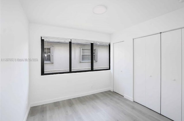 unfurnished bedroom featuring light wood-type flooring