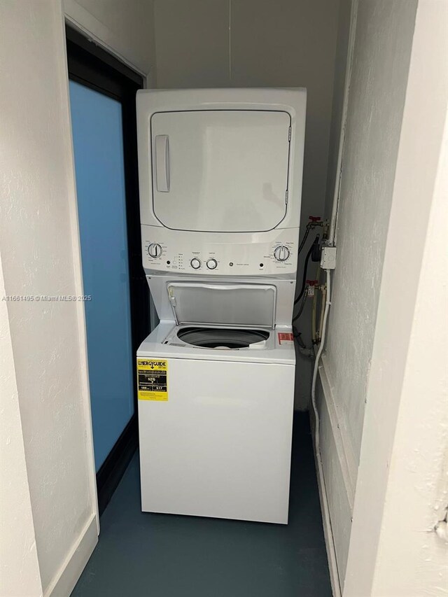 laundry area with stacked washing maching and dryer