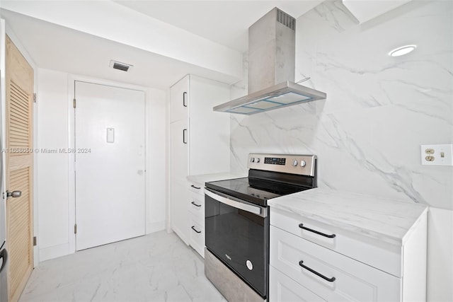 kitchen with white cabinets, stainless steel electric range, and extractor fan