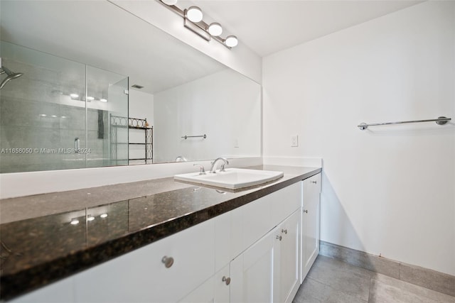 bathroom with vanity and a shower with door