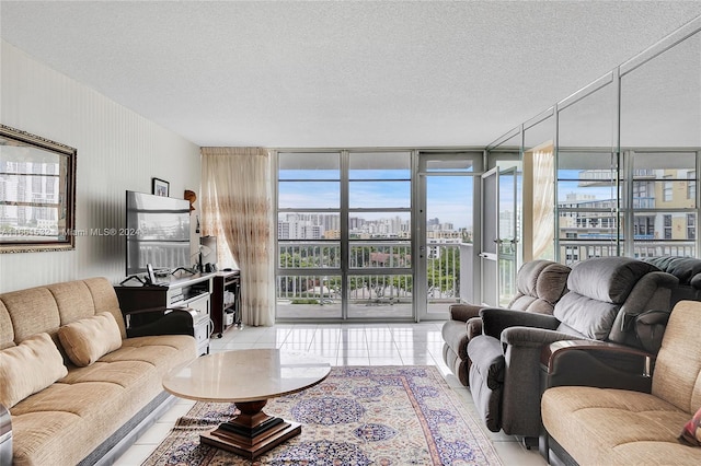 living room with plenty of natural light, expansive windows, a textured ceiling, and light tile patterned floors