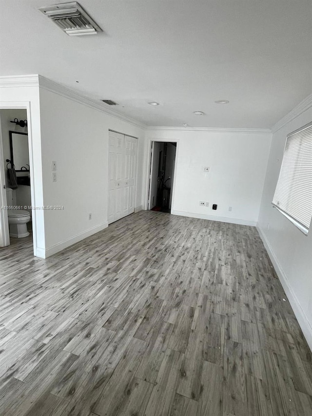 interior space featuring light hardwood / wood-style flooring and ornamental molding