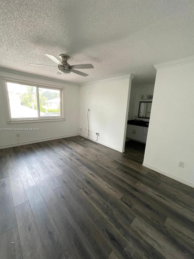 empty room with a textured ceiling, crown molding, dark hardwood / wood-style floors, and ceiling fan