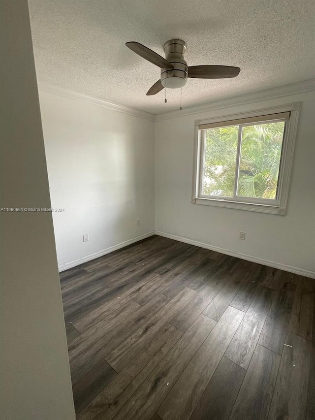 unfurnished room featuring dark hardwood / wood-style flooring, ceiling fan, ornamental molding, and a textured ceiling