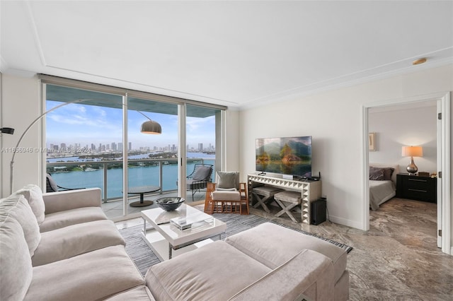 living room featuring a water view, crown molding, and expansive windows