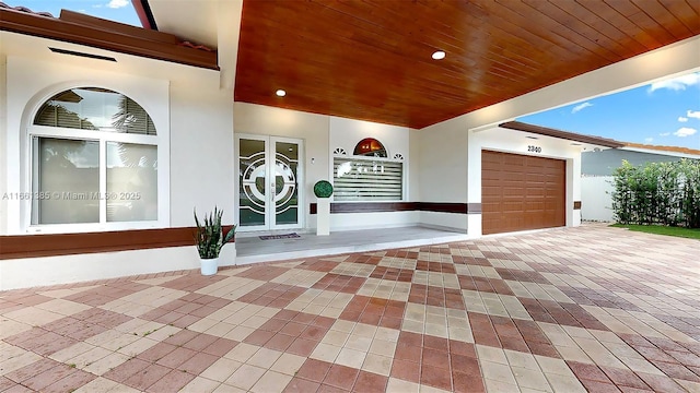 view of patio featuring a porch and a garage